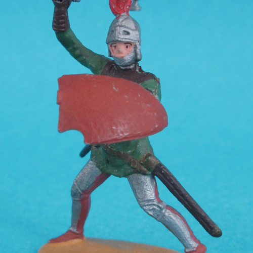 1237  Chevalier se défendant, bras droit levé, bouclier au bras gauche, casque à plumet.