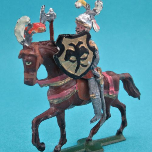 Chevalier casque à 3 plumets, visière ouverte, sur cheval sellé au trot, avec écu aigle et hache.