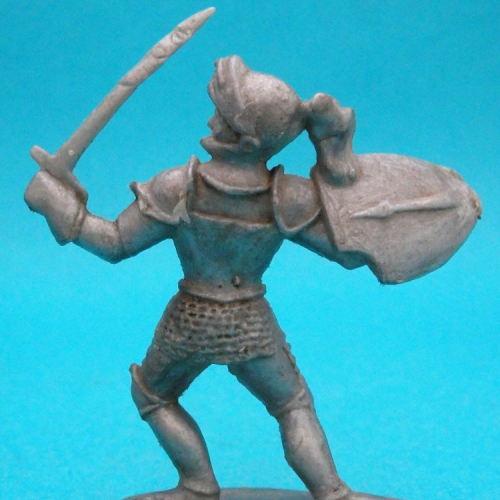 MAN/DOM 03. Chevalier tête vers la gauche, visière ouverte, épée et bouclier levés.